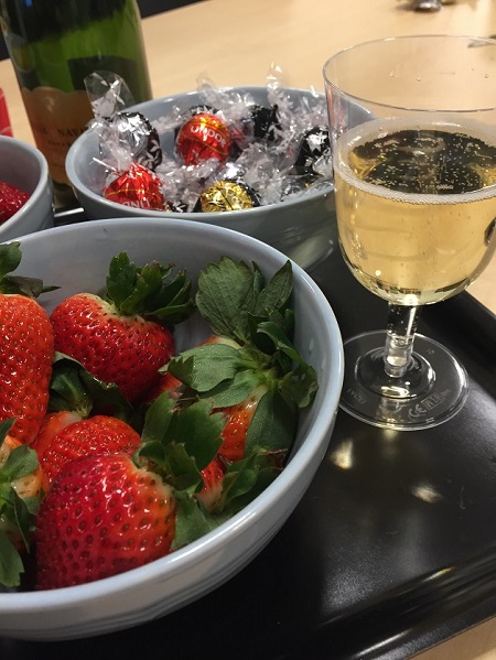 Celebration with strawberries, champagne, and chocolate.